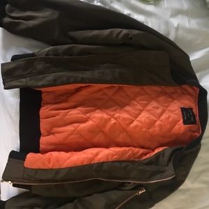 Green bomber jacket with orange inside lining